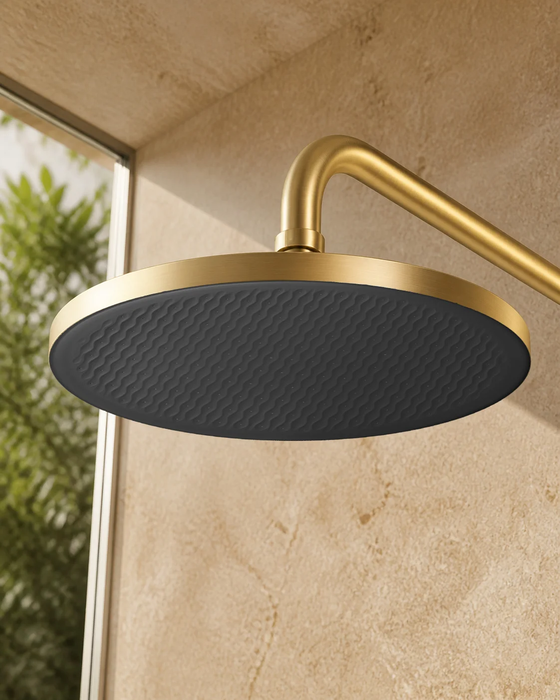 Low angle of the brushed gold Rima rain head with its matte black face