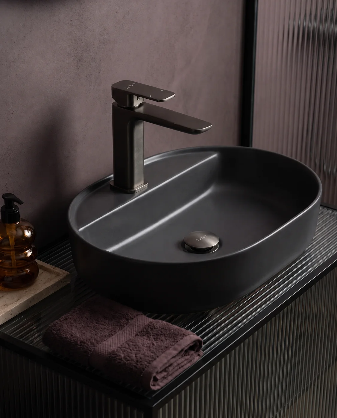 Gun grey Tala mixer with a charcoal oval basin and plum walls