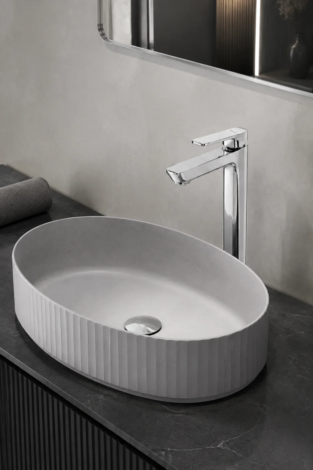 Chrome Tala Vessel mixer with a grey fluted oval basin on dark stone