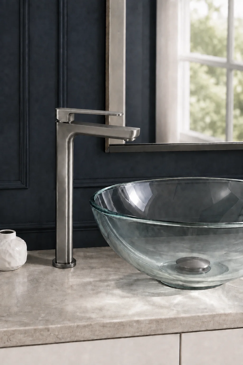 Gun grey Tala Vessel mixer with a clear glass bowl against navy walls
