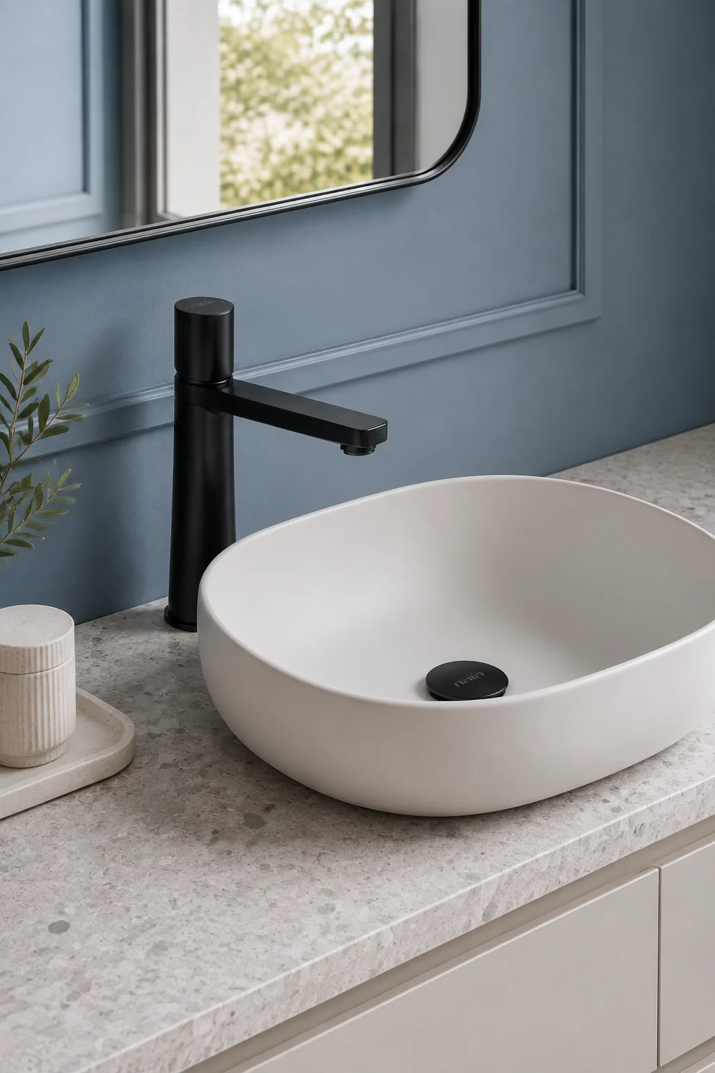 Matte black Lian mixer with a white sculpted basin against dusty blue panelling