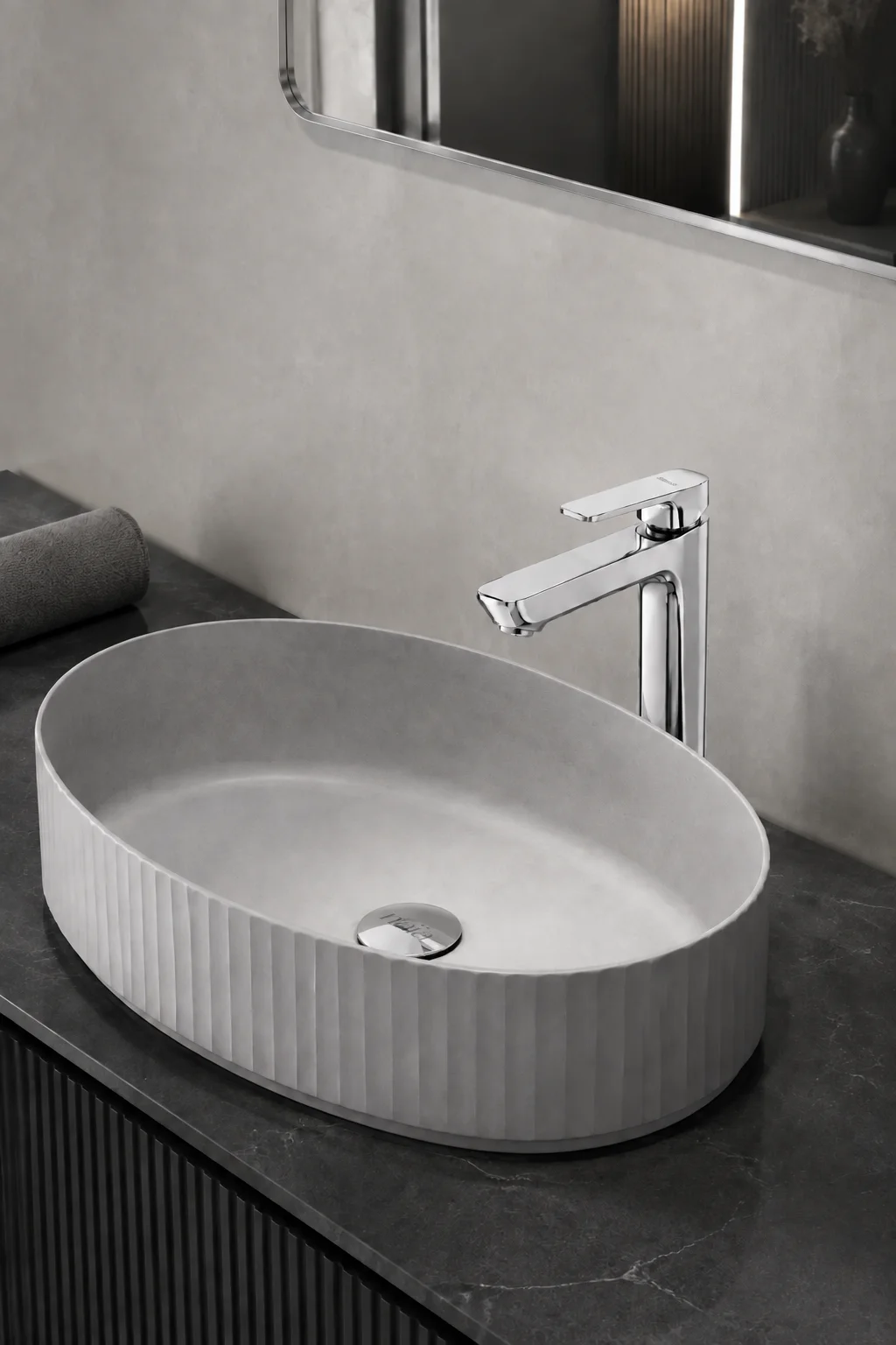 Chrome Tala mixer with a grey fluted oval basin on dark stone