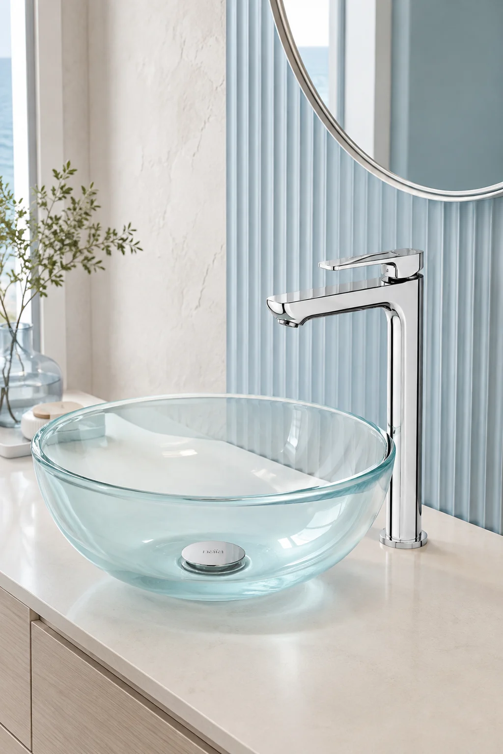 Chrome Tala Vessel mixer with an aqua glass bowl and powder blue wall