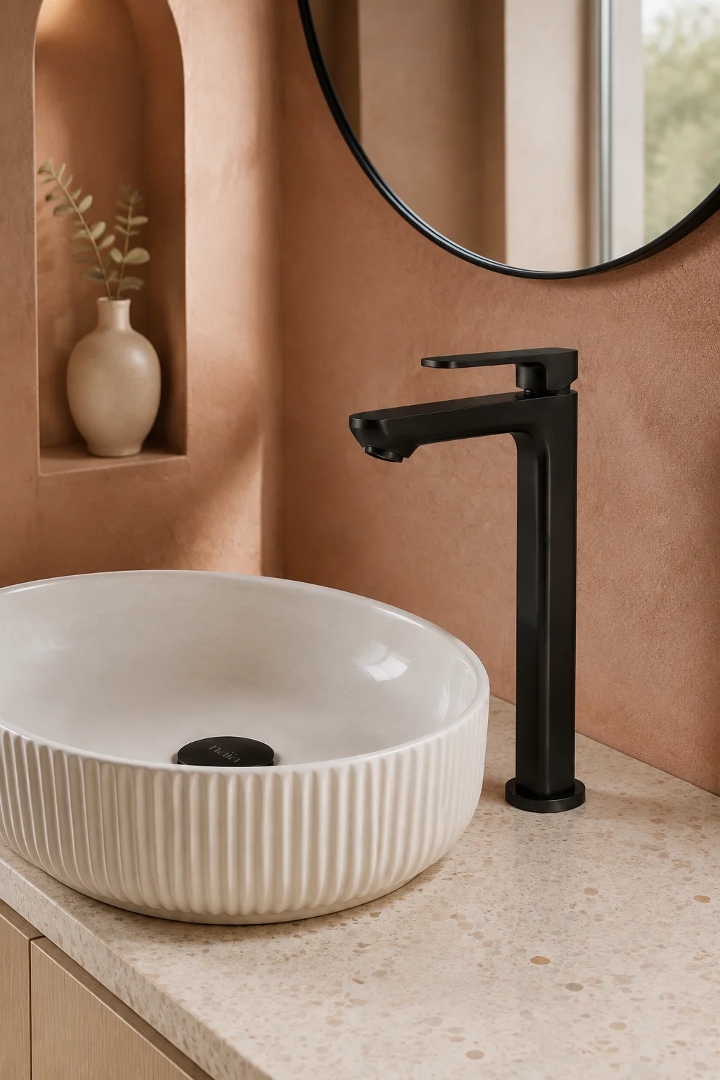 Matte black Tala Vessel mixer with an ivory fluted basin and terracotta walls
