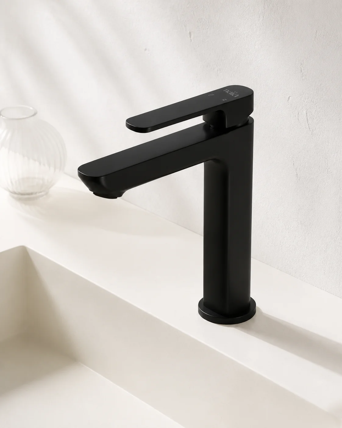 Top angle of the matte black Tala mixer over a white integrated basin