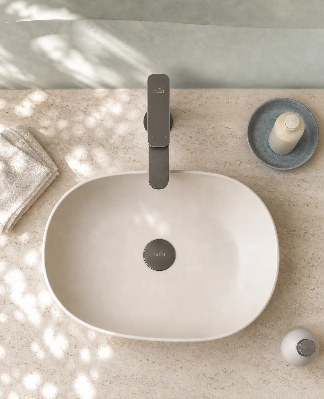 Top view of the gun grey Tala mixer and matching waste in a cream basin