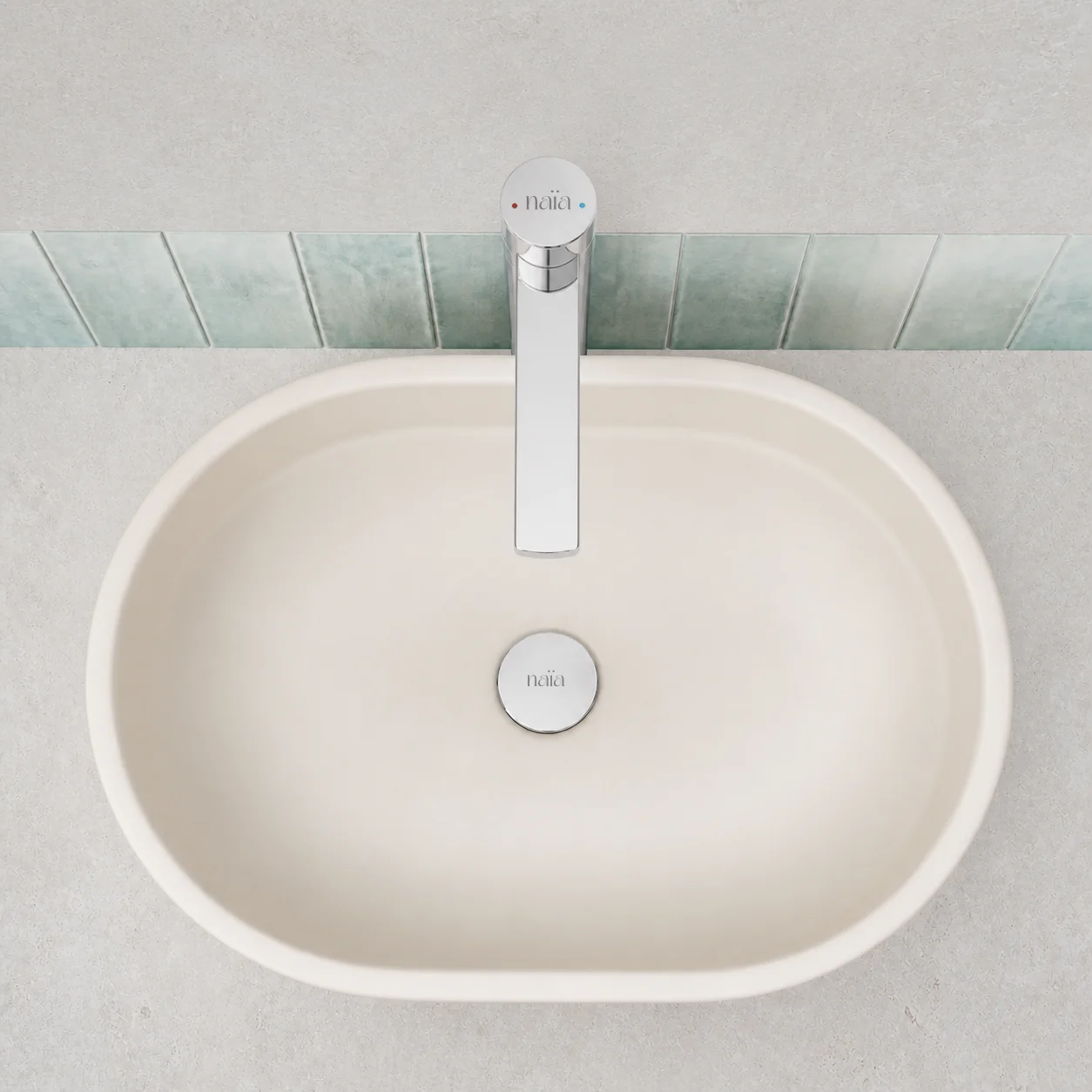 Top view of the chrome Lian mixer and matching waste in a cream oval basin